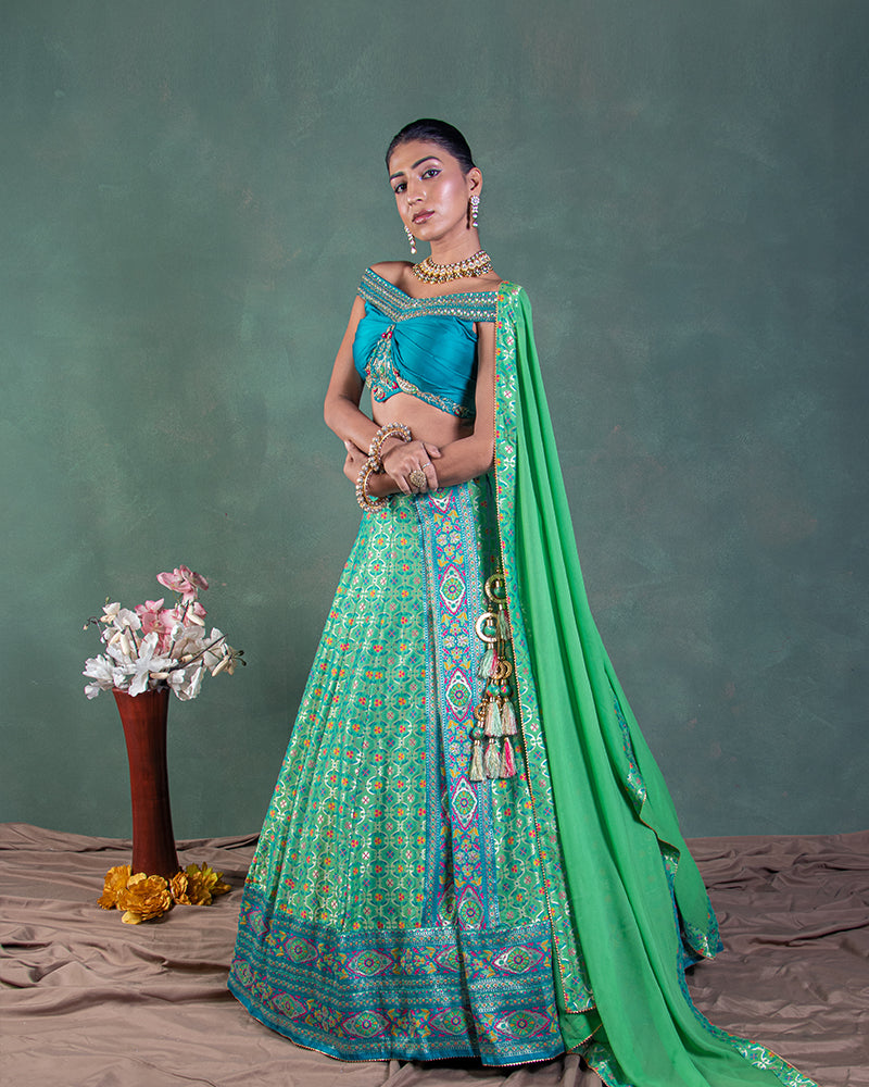 Green silk lehenga with off shoulder blouse and dupatta