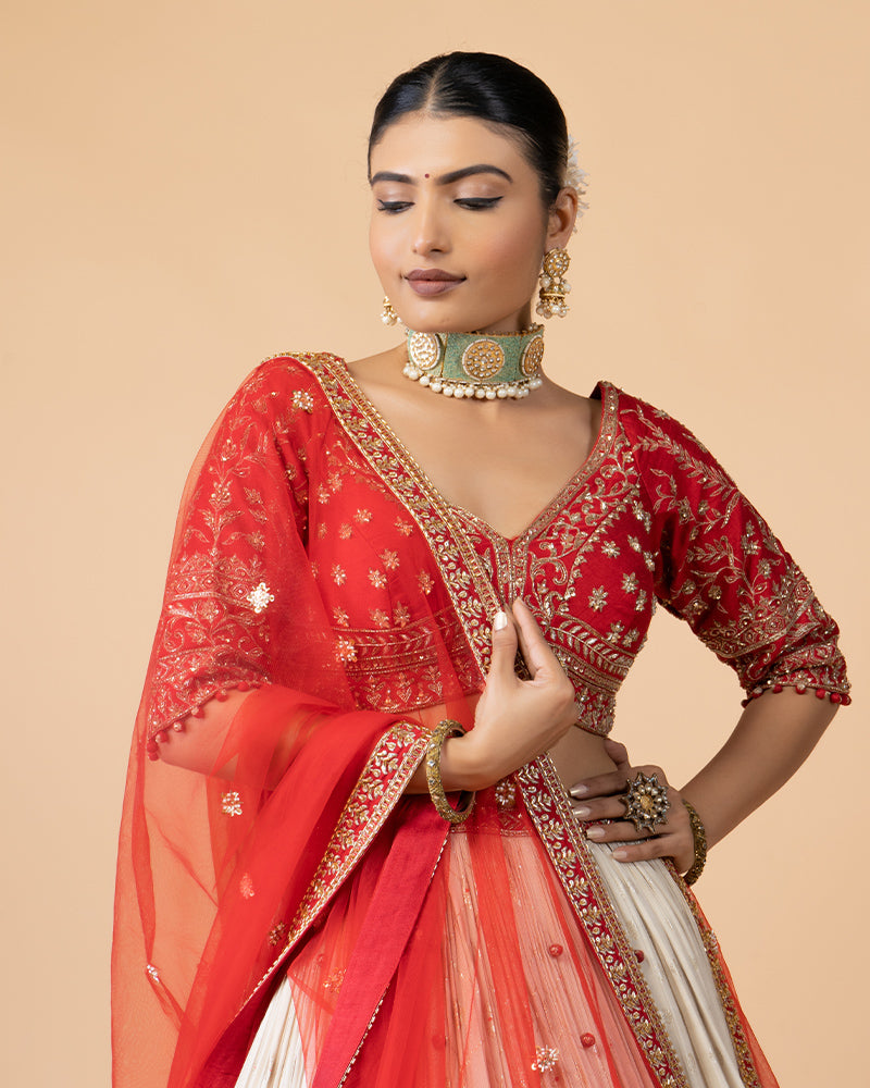 Cream Lehenga with Golden Embroidery, Heavy Red Choli, and Draped Net Dupatta